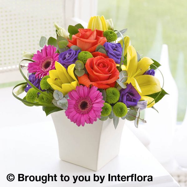 colourful arrangement in a cream pot